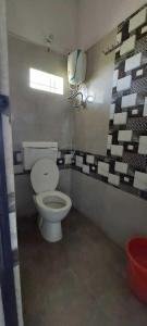 a bathroom with a toilet and a mirror at SPOT ON Hotel Rs Inn in Nagpur