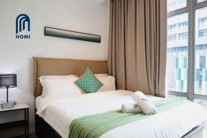 Postel nebo postele na pokoji v ubytování Homi Oasis at KK Times Square 和逸绿洲