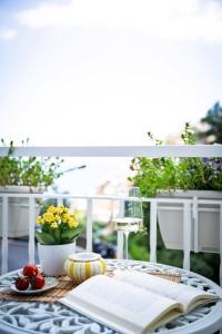 a table with an open book and a plate of food at House on the rock in Positano