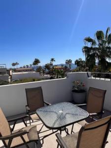 a patio with a table and chairs on a balcony at Casa Las Victorias in Loreto +19 photos