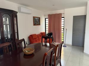 a dining room with a table and a couch at Casa en Mazatlán in Mazatlán