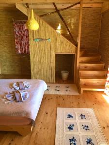 a bedroom with a bed and a fireplace in a log cabin at Large Bungalow with Sea View in Kabak Bay, Ölüdeniz in Fethiye