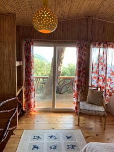 a room with a bed and a large window at Large Bungalow with Sea View in Kabak Bay, Ölüdeniz in Fethiye