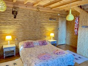 a bedroom with a bed and two tables and two lamps at Large Bungalow with Sea View in Kabak Bay, Ölüdeniz in Fethiye