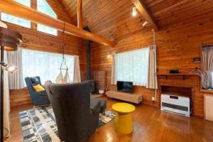 a living room with a couch and a fireplace at S-villa Karuizawa - Princeland - in Tsumagoi