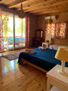 a bedroom with a bed in a room with a view of a pool at Large Bungalow with Sea View in Kabak Bay, Ölüdeniz in Fethiye