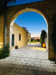 an entrance to a brick building with an archway at Villa Casole Short Lets in Copertino