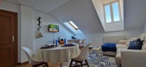 a living room with a table and chairs at Junto a la Catedral in Burgos
