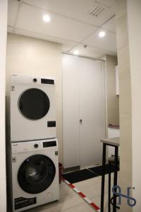 a washer and dryer in a room with a table at Homi Breeze 和逸微风 in Kota Kinabalu