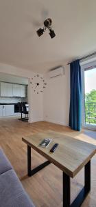 a living room with a table and a couch at Central apartment with city view in Braşov