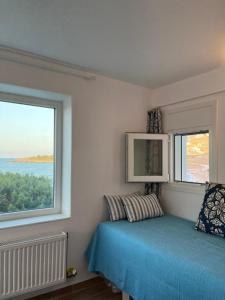 A bed or beds in a room at Seafront Villa Polyxene