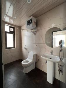 a bathroom with a toilet and a sink at THE GETAWAY in Shimla