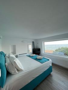 A bed or beds in a room at Seafront Villa Polyxene