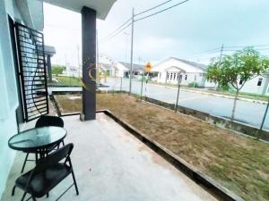 a balcony with a table and chairs and a view of a street at Qairissa Homestay Kuantan in Kuantan