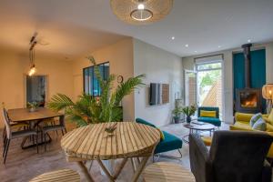 a living room with a table and a dining room at O'Myosotis in Sarlat-la-Canéda