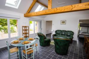a living room with a table and chairs at La Créquoise in Offin