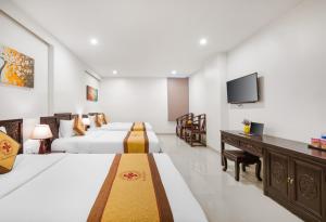 Voodi või voodid majutusasutuse Hoa Phong Airport Danang Hotel toas