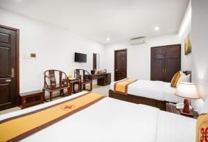 Voodi või voodid majutusasutuse Hoa Phong Airport Danang Hotel toas