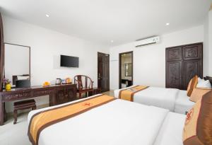 Voodi või voodid majutusasutuse Hoa Phong Airport Danang Hotel toas