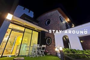 a building with a sign that says stay around at STAY AROUND in Jeju