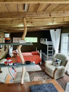 a bedroom with a bed and a loft at Yn Y Coed Tanyrallt in Llanybyther +34 photos