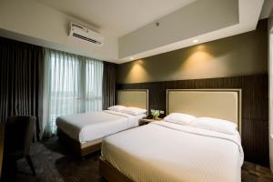Postel nebo postele na pokoji v ubytování Sotogrande Hotel Katipunan