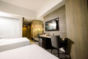 Postel nebo postele na pokoji v ubytování Sotogrande Hotel Katipunan