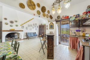a kitchen and living room with plates on the wall at casa Camilla in Torre delle Stelle