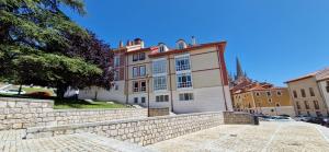 a building with a stone wall in front of it at Junto a la Catedral in Burgos