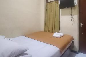 Ένα ή περισσότερα κρεβάτια σε δωμάτιο στο Hotel Malang near Alun Alun Malang RedPartner