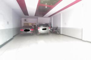 two cars are parked in a garage at Hotel Malang near Alun Alun Malang RedPartner in Malang