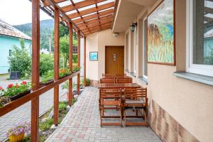 a row of chairs sitting on a porch at Penzión Brest Habovka in Habovka