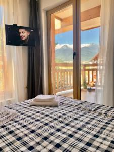 a bedroom with a bed with a tv on the wall at Studio Chalet 13, St John Park Bansko in Bansko