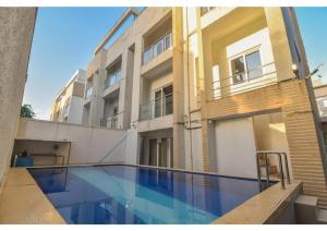 a swimming pool in front of a building at Nestle Villa 5BHK in Lonavala