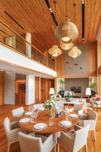 a dining room with a table and chairs at Aquella Lakeside Villas in Thai Muang