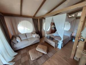 an aerial view of a bedroom with a couch and a bed at Wine Glamping Le Sedici in Massa Marittima