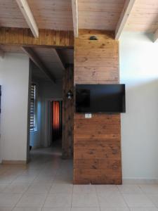 a wooden wall with a flat screen tv on it at Ajloun Forest Reserve in Ajloun