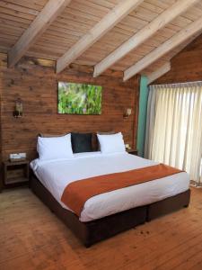 a bedroom with a large bed in a wooden room at Ajloun Forest Reserve in Ajloun +151 photos