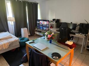 Habitación con escritorio, ordenador y cama. en Studio Nîmes, en Nimes