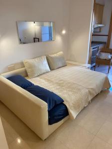 a large bed in a room with a mirror at Costa del Golf in Torre de Benagalbón