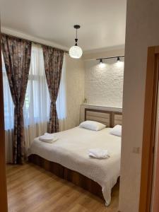 a bedroom with a bed with two towels on it at Guesthouse SHAMPRIANI in Mestia