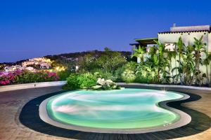 a swimming pool in the middle of a yard at ISA-Residence wityh swimming-pool near Porto Cervo and only 350 meters from the beach in Liscia di Vacca
