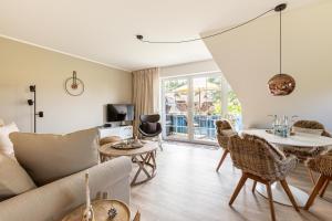 a living room with a couch and a table at Schöne Aussichten in Wieck