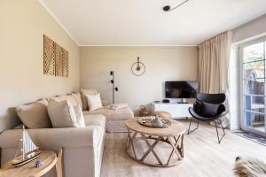 a living room with a couch and a table at Schöne Aussichten in Wieck