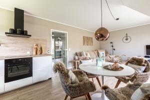 a kitchen and living room with a table and chairs at Schöne Aussichten in Wieck
