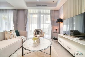 a living room with a couch and a table at Magnificent 3BR Townhouse at DAMAC Hills 2, Dubailand by Deluxe Holiday Homes in Dubai