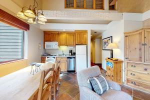 a kitchen with a wooden table and a dining room at The Lodge at Mountain Village Unit 308 A and B in Park City