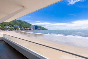 a view of the beach from the balcony of a condo at Palm Villa 23 (Beachfront Pool Villa Vung Tau with an Ocean view and Karaoke, Billards) in Vung Tau