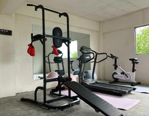 a gym with two tread machines and a mirror at Erzhuo Valley in Furong Town - Among the Clouds 