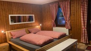 a bedroom with two beds and a window at Vedder's Berghütte in Herscheid